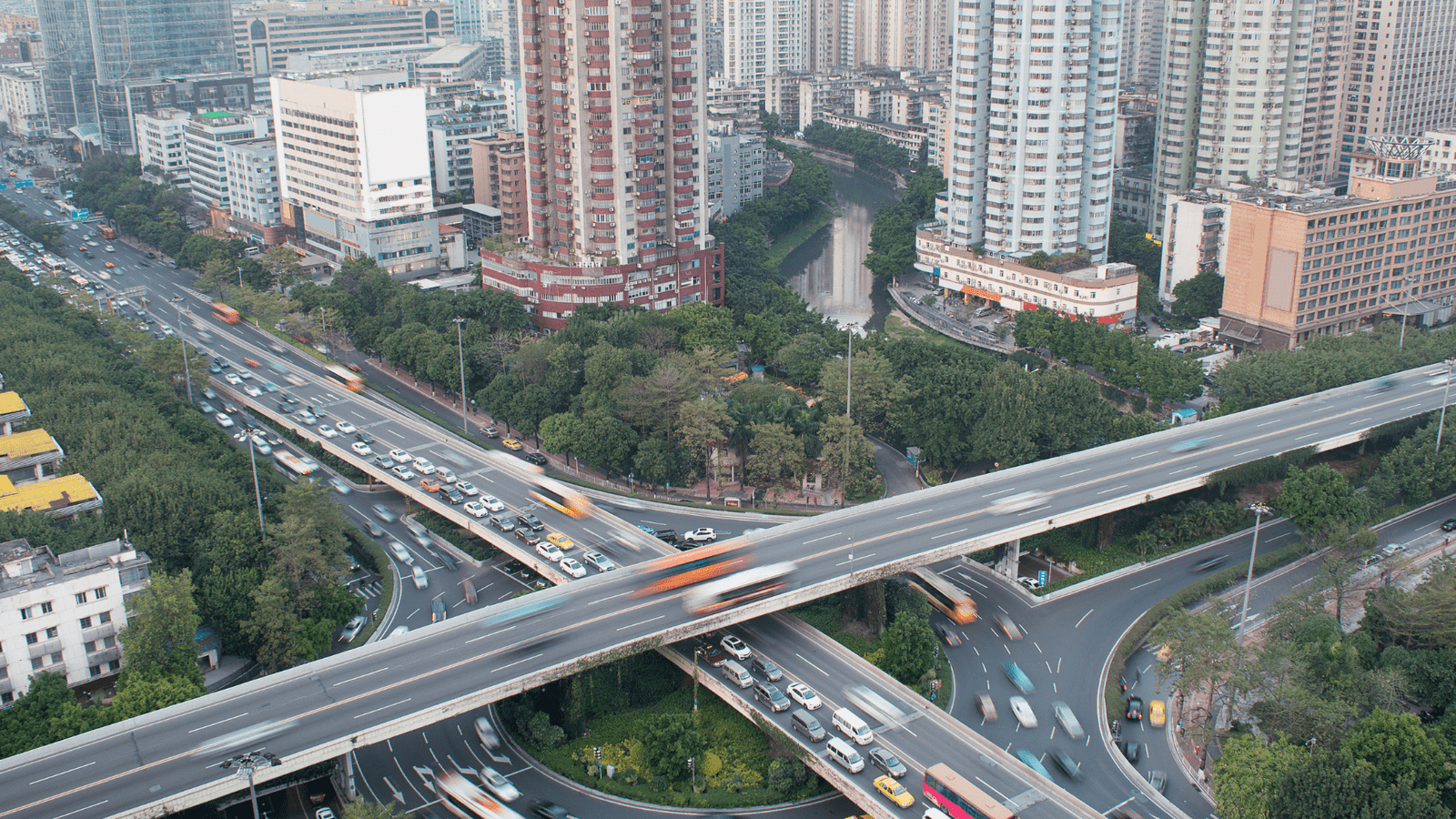 A vibrant urban street scene in Manila, Philippines, showcasing a variety of cars and towering buildings in the background.