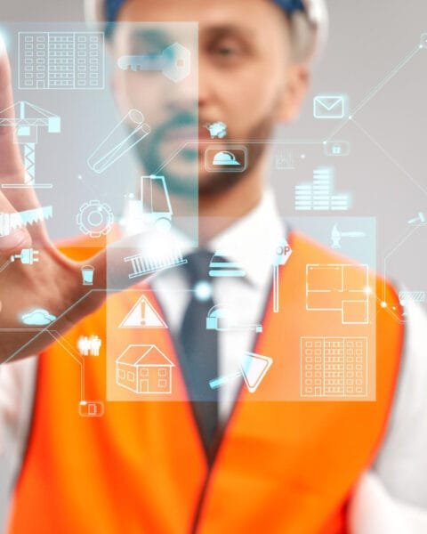 Philippines Digital Construction Tools: Person in a safety vest interacting with futuristic holographic construction icons.